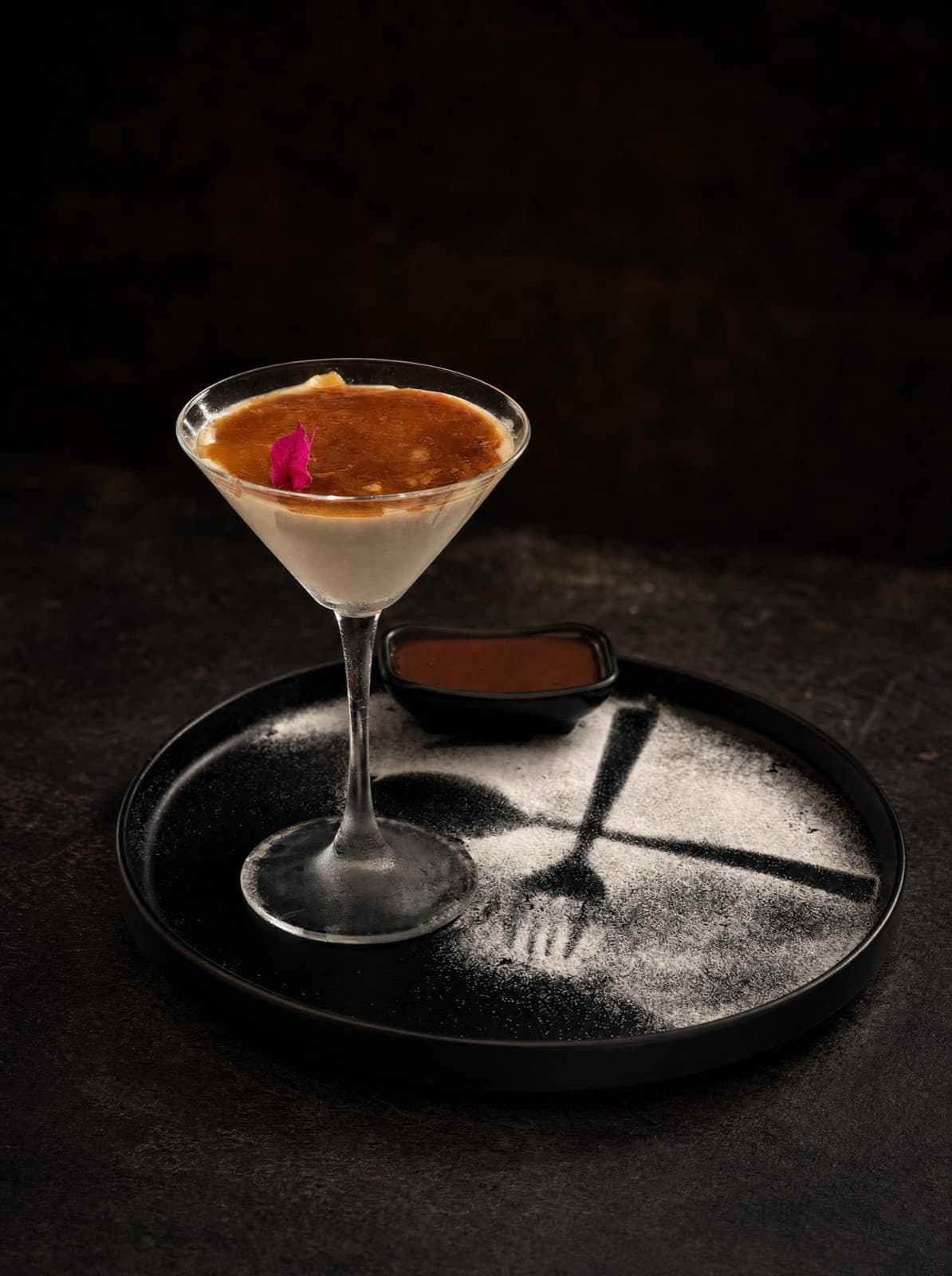 Chilled dessert in a stemmed glass, finished with a rose petal