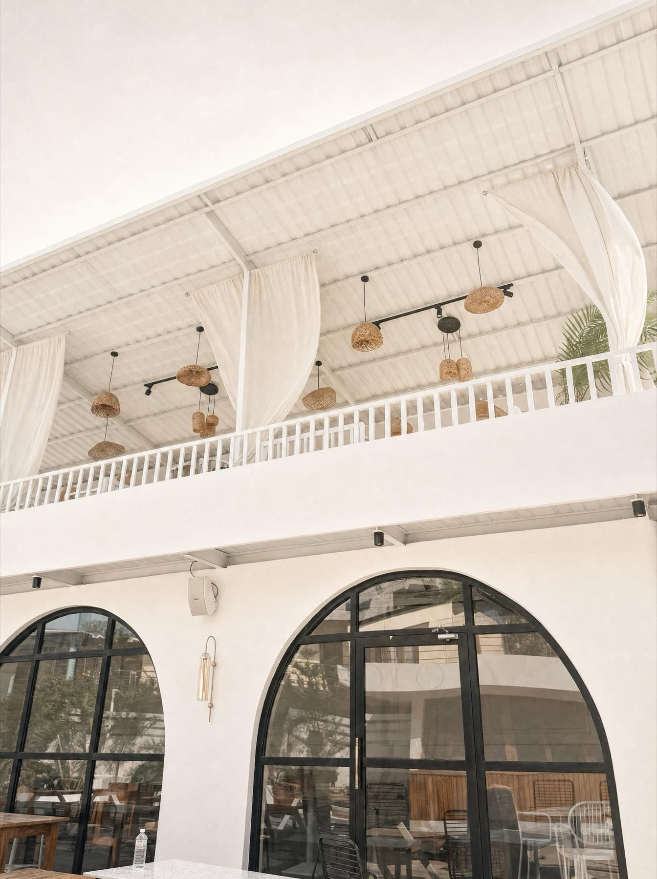 Arched entrance below the draped rooftop terrace
